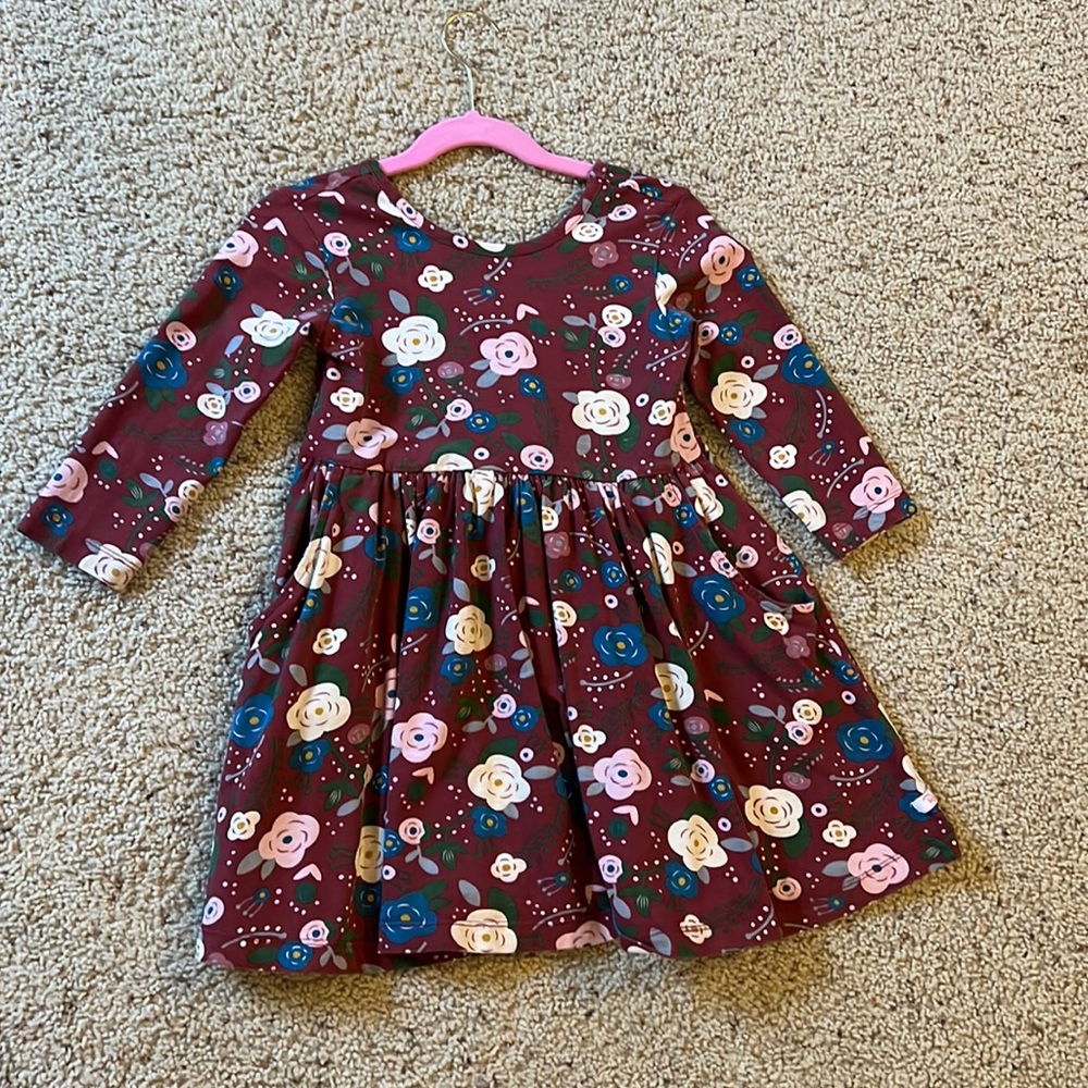 Ruffle butts twirl dress with bow and pockets.